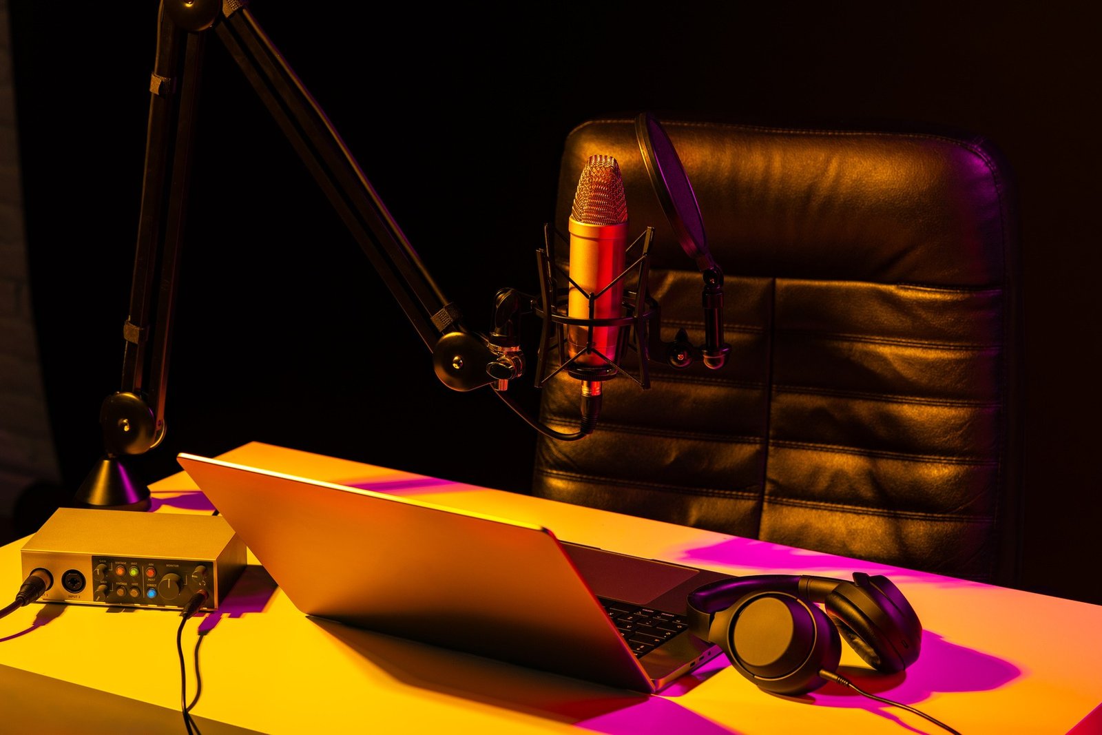 Home studio podcast interior. Microphone, table and chair Home studio podcast interior. Microphone, table and chair close up